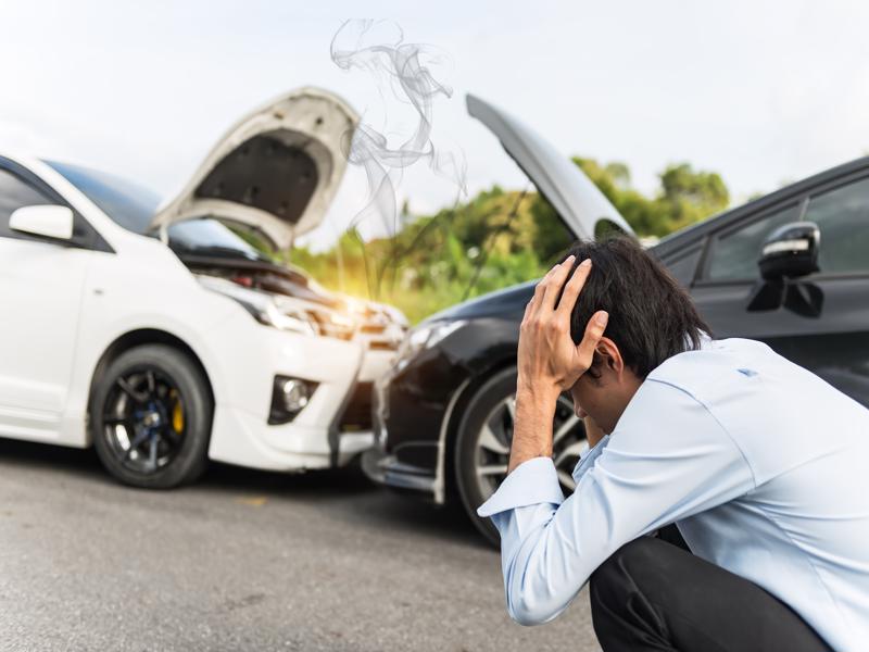 A man is stressed out after being involved in a car accident.