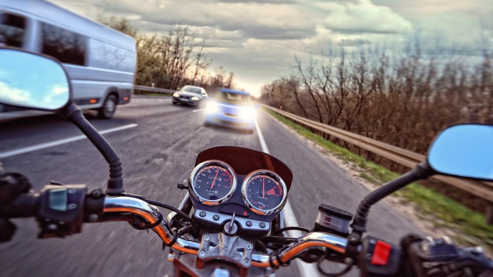 A motorcycle is seen about to collide with a car head on, as it travels in the wrong direction.