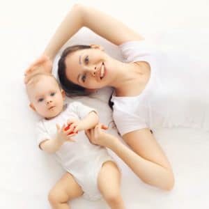 A mother and baby are shown on white background.