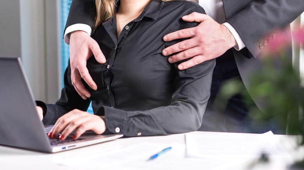 A woman is being groped by her boss at work. Sexual assault