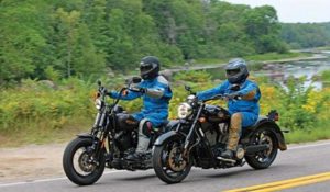 Two motorcycle riders riding abreast