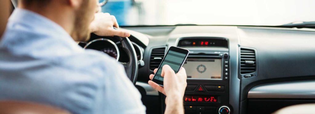 Driver using his cell phone while driving