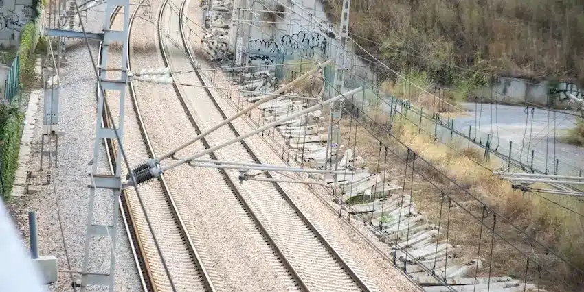 An aerial view of railway tracks and infrastructure where railroad worker rights and safety regulations are enforced in Texas.