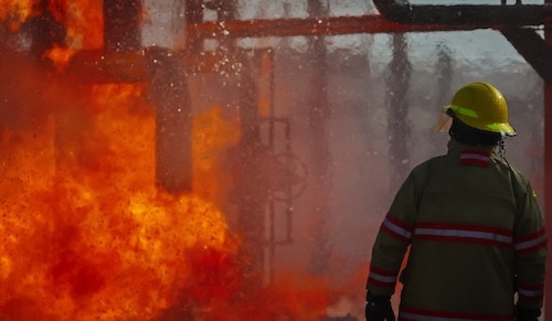 Fireman Overlooking Refinery Explosions